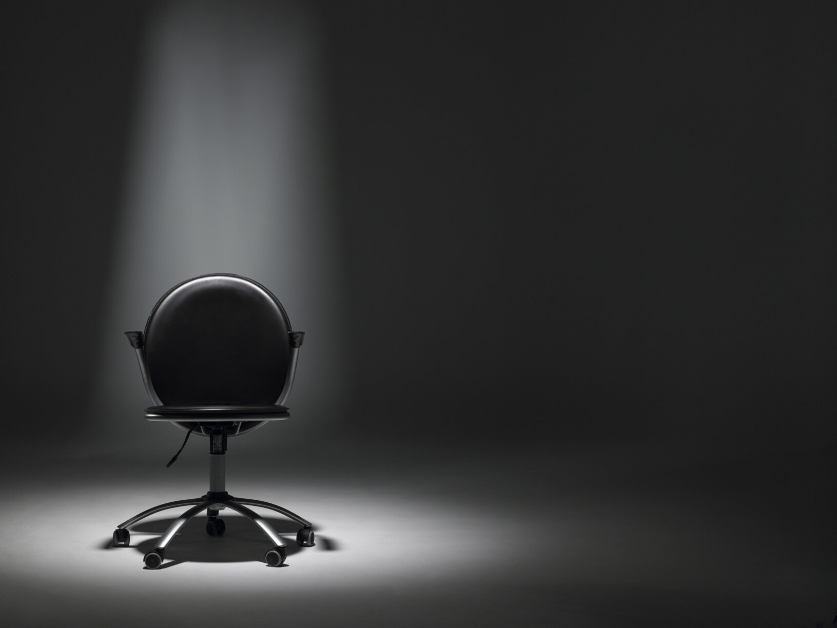 Empty Office Chair in Spotlight